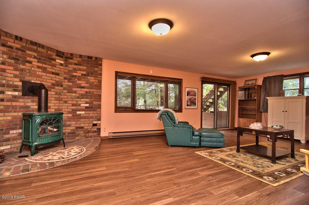 3042 Northgate Road Lake Ariel, PA 18436 - Photo 27 of 37 a living room with furniture and a floor to ceiling window