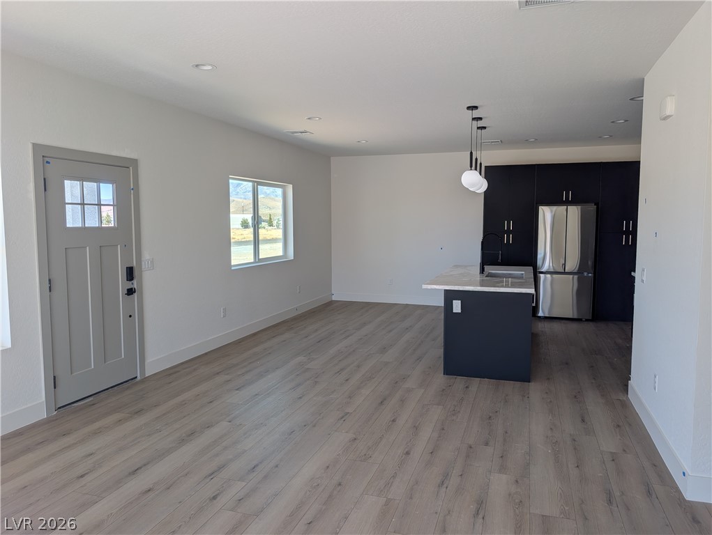 4670 Medicine Man Road Pahrump, NV 89048 - Photo 6 of 36 A well-lit, open-concept living space seamlessly connects the entry to a modern kitchen.