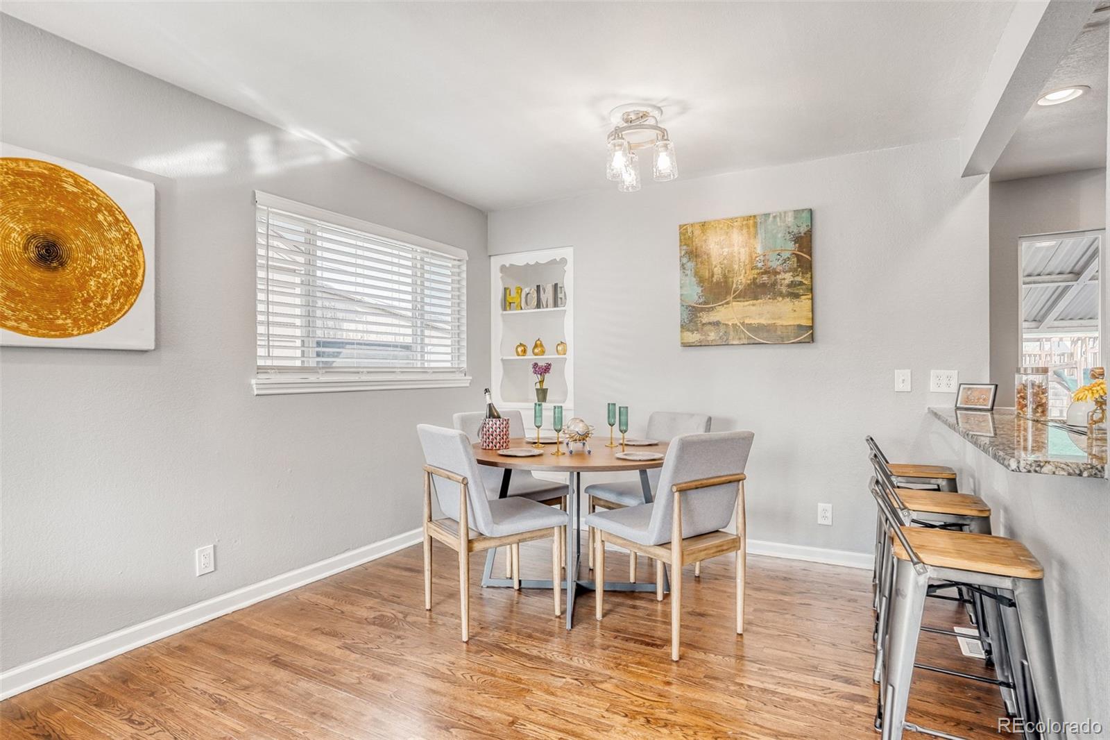 2356 Florence Street Aurora, CO 80010 - Photo 13 of 31 a view of a dining room with furniture and wooden floor