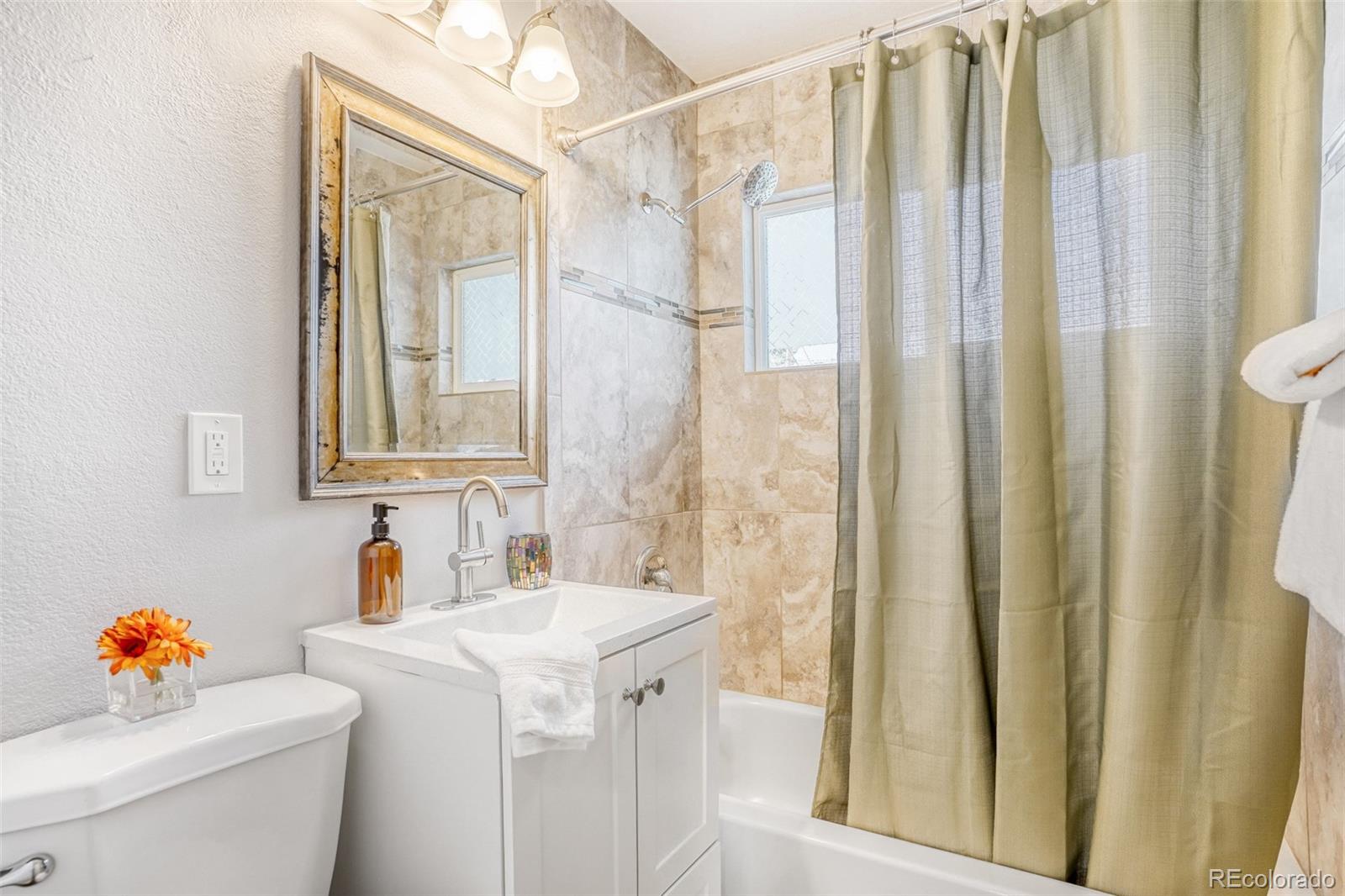 2356 Florence Street Aurora, CO 80010 - Photo 17 of 31 a bathroom with a sink toilet and shower