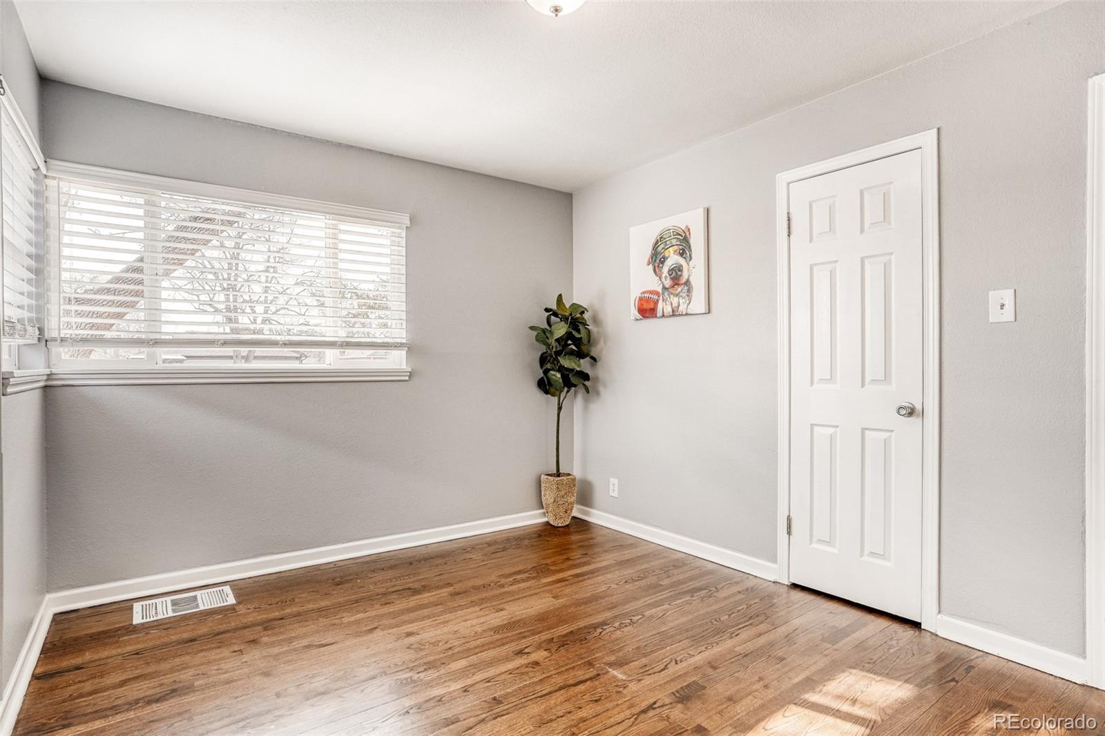 2356 Florence Street Aurora, CO 80010 - Photo 19 of 31 a view of a livingroom with wooden floor and a window
