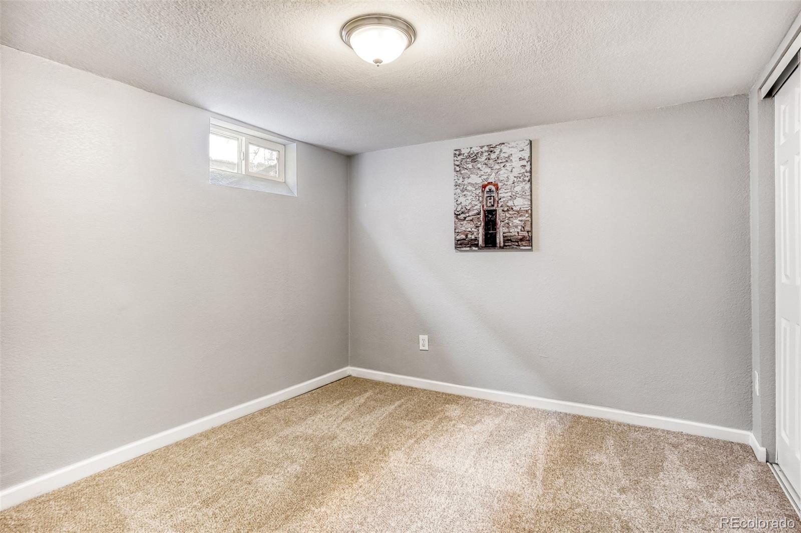 2356 Florence Street Aurora, CO 80010 - Photo 25 of 31 an empty room with a window