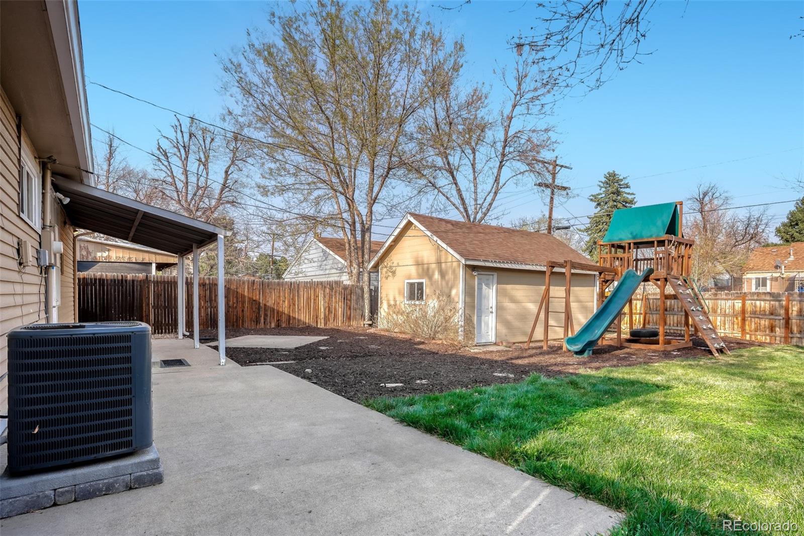 2356 Florence Street Aurora, CO 80010 - Photo 26 of 31 a view of a house with backyard and a tree