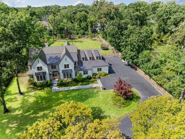 an aerial view of residential houses with yard and swimming pool