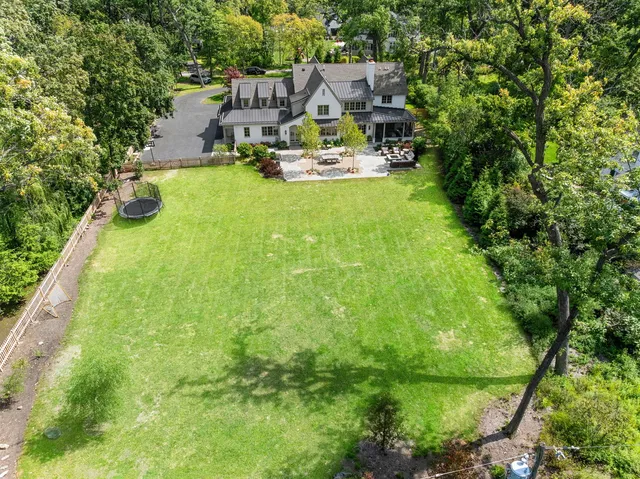 an aerial view of a house with swimming pool garden and patio