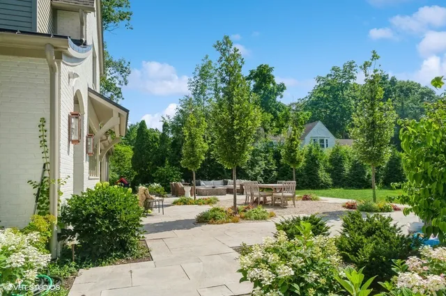a view of a patio with table and chairs and potted plants