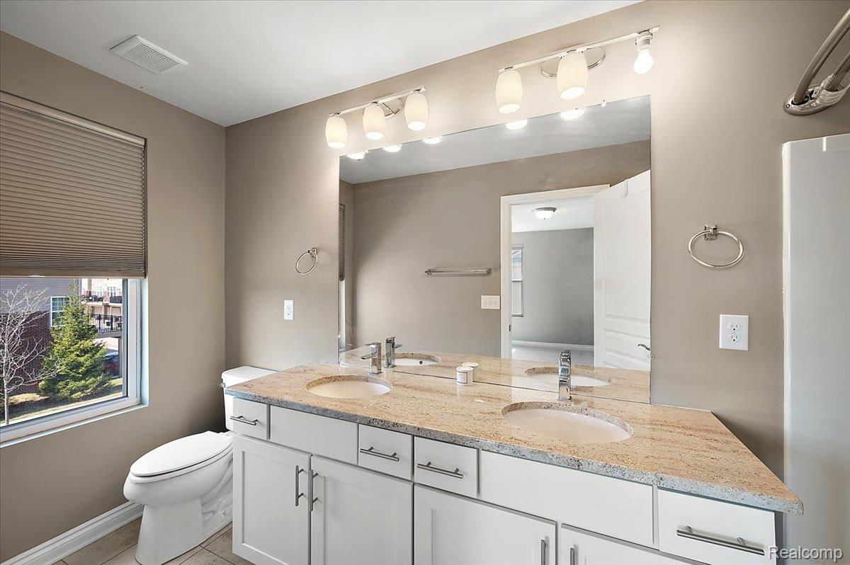 2877 Hartwick Drive Rochester, MI 48307 - Photo 29 of 44 Full bath with double vanity and light tile patterned flooring