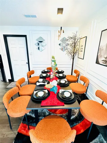 a dining room with a table and chairs