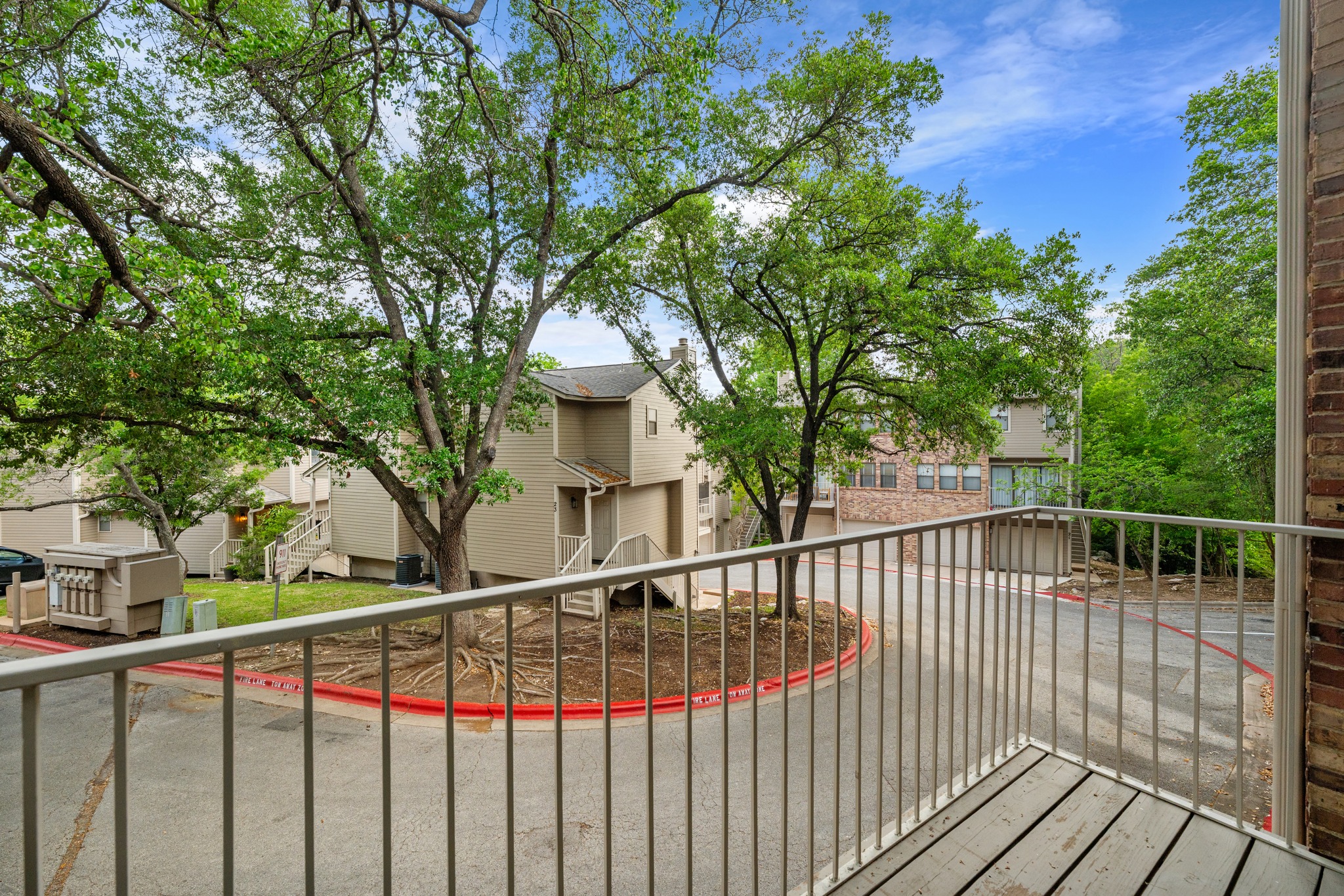 3845 Ranch Road 2222, Unit 19 Austin, TX 78731 - Photo 12 of 38 a view of a balcony with wooden floor and fence