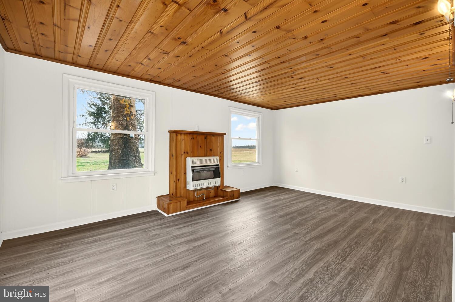 6746 Quaker Neck Road Chestertown, MD 21620 - Photo 35 of 50 a view of an empty room with wooden floor and a window
