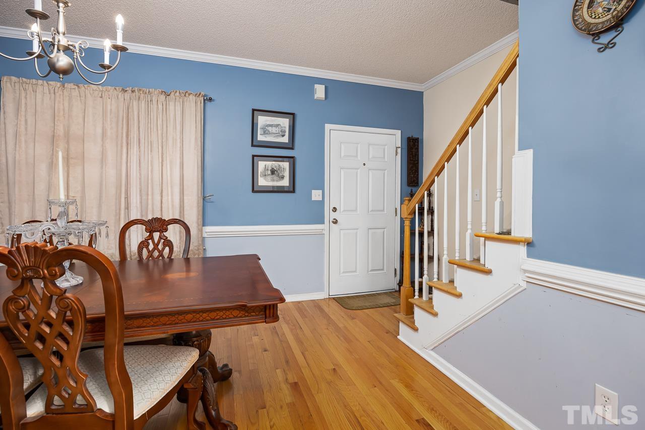 229 Roping Horn Way Willow Spring, NC 27592 - Photo 11 of 30 a view of a dining room with furniture and wooden floor
