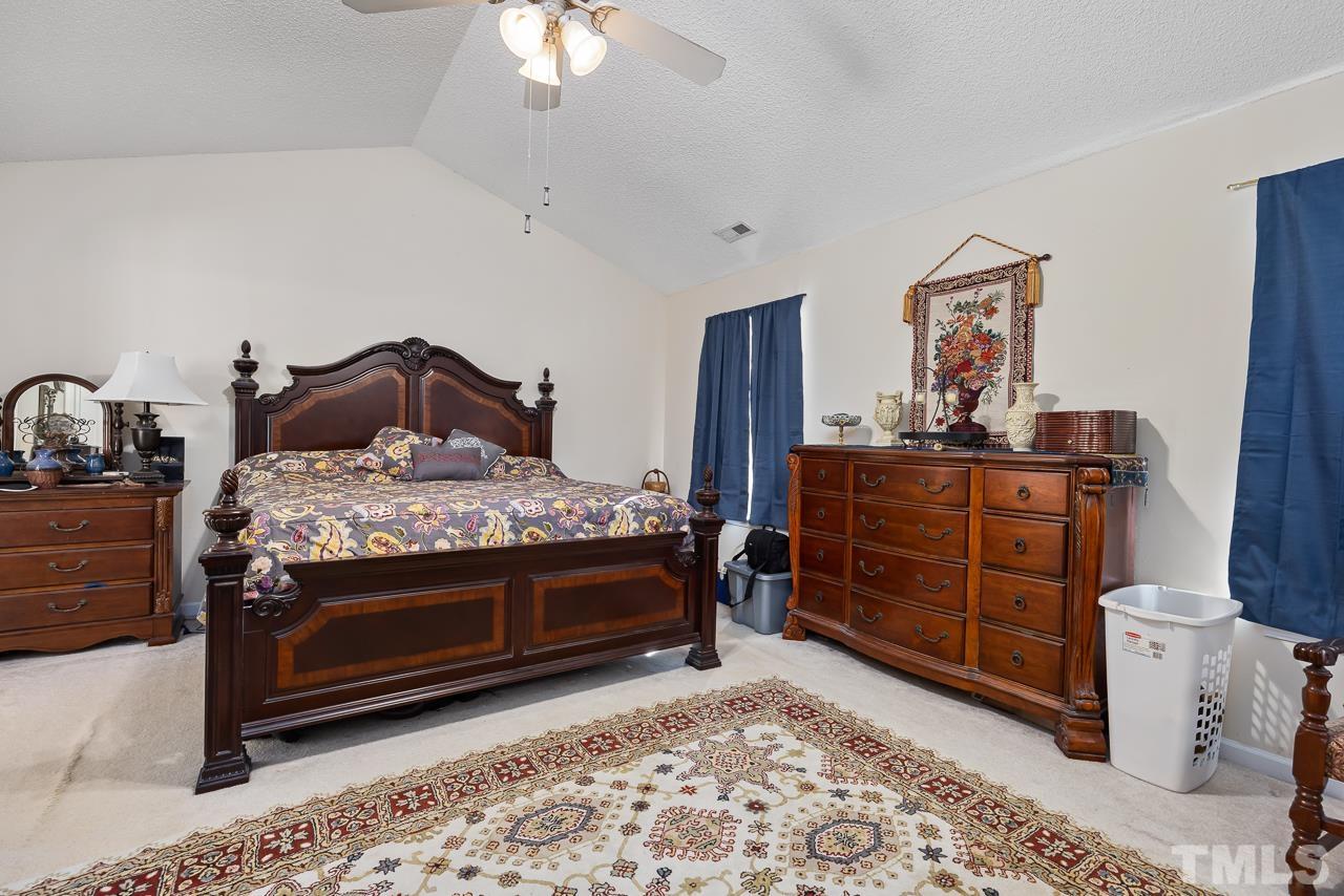 229 Roping Horn Way Willow Spring, NC 27592 - Photo 12 of 30 a bed room with a bed and a dresser