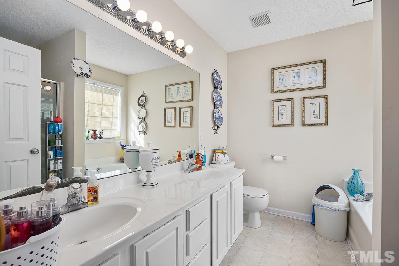 229 Roping Horn Way Willow Spring, NC 27592 - Photo 14 of 30 a bathroom with a double vanity sink mirror and toilet