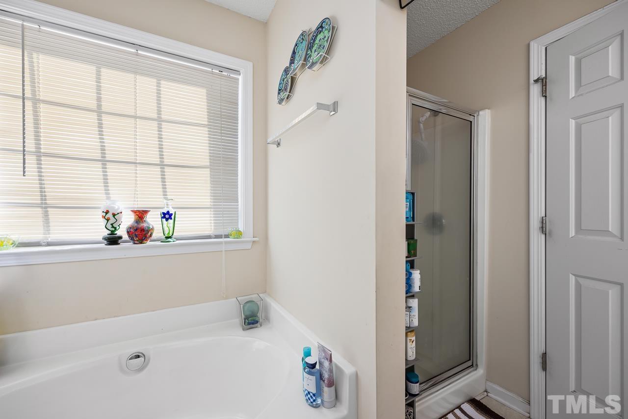 229 Roping Horn Way Willow Spring, NC 27592 - Photo 15 of 30 a bathroom with a tub and a shower