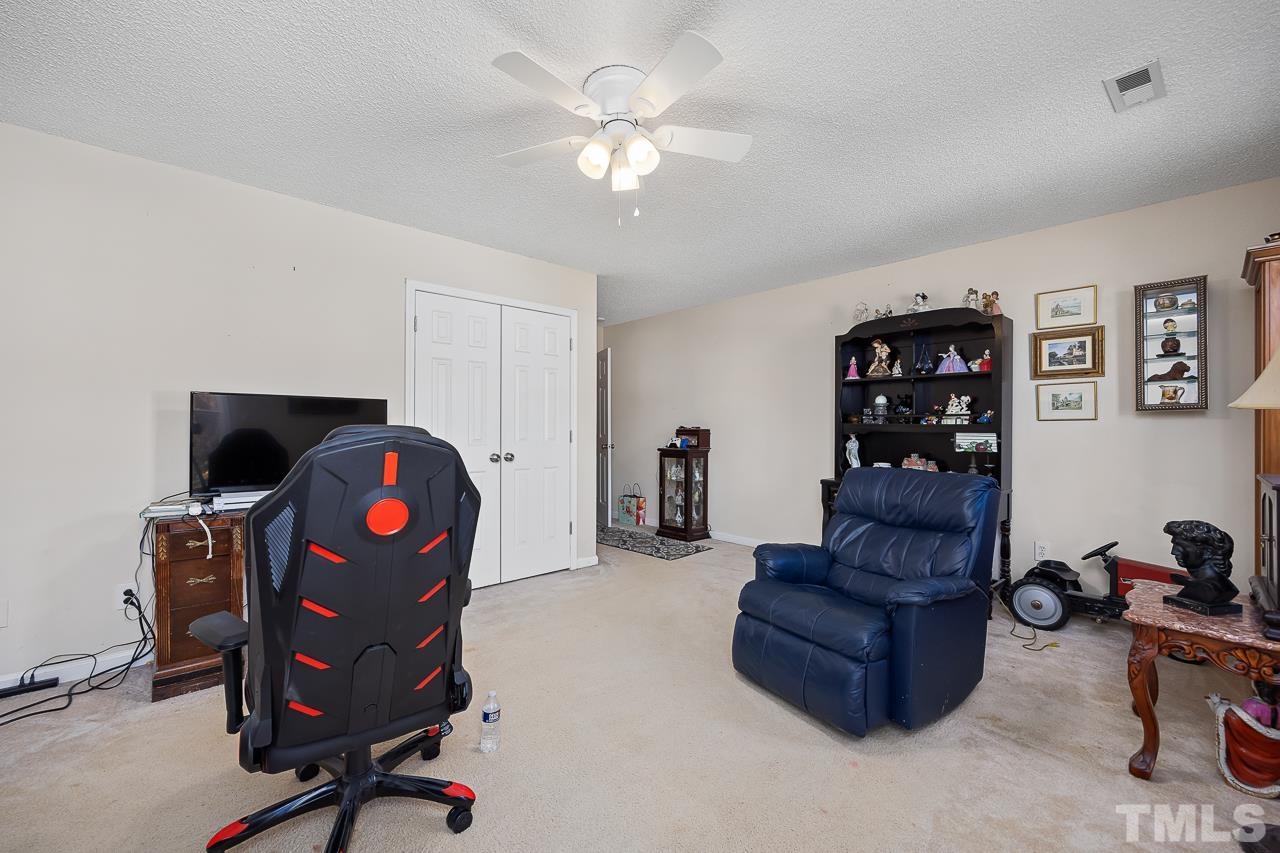 229 Roping Horn Way Willow Spring, NC 27592 - Photo 20 of 30 a view of a workspace with furniture and a chandelier fan