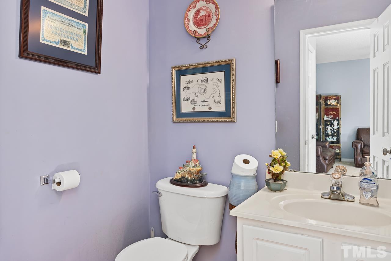 229 Roping Horn Way Willow Spring, NC 27592 - Photo 23 of 30 a bathroom with a sink mirror and toilet