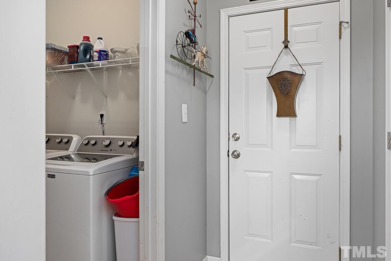 229 Roping Horn Way Willow Spring, NC 27592 - Photo 25 of 30 a kitchen with a refrigerator and cabinets