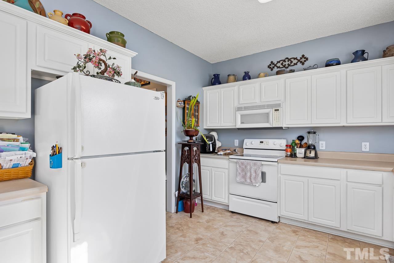 229 Roping Horn Way Willow Spring, NC 27592 - Photo 6 of 30 a white refrigerator freezer sitting in a kitchen
