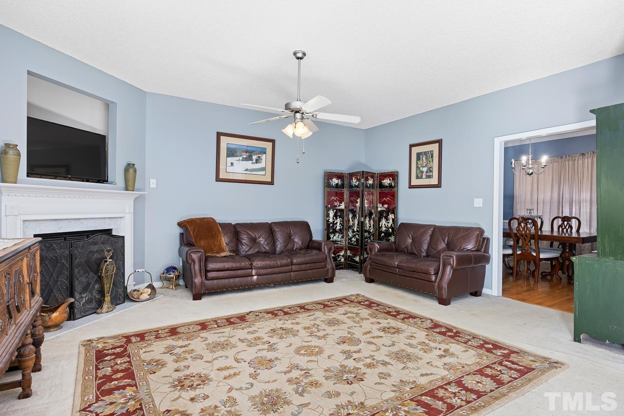 229 Roping Horn Way Willow Spring, NC 27592 - Photo 8 of 30 a living room with furniture and a fireplace