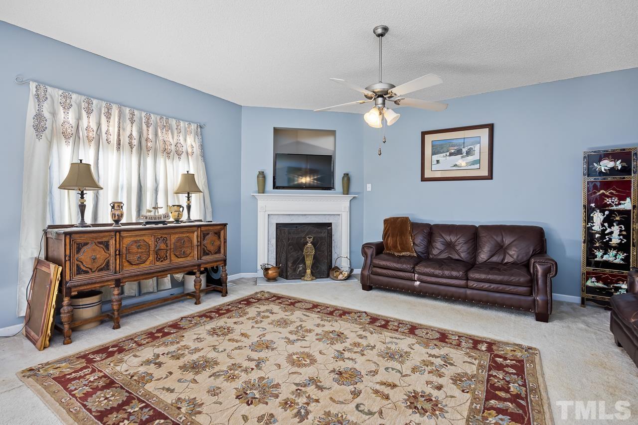 229 Roping Horn Way Willow Spring, NC 27592 - Photo 9 of 30 a living room with furniture and a fireplace