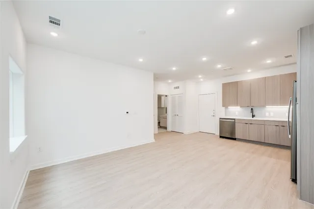 a view of a kitchen with a sink and cabinets