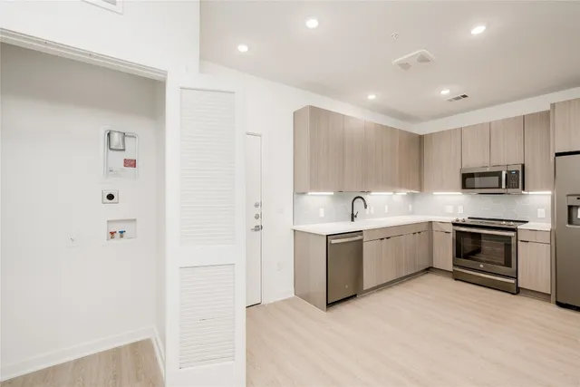 a kitchen with a sink and stainless steel appliances