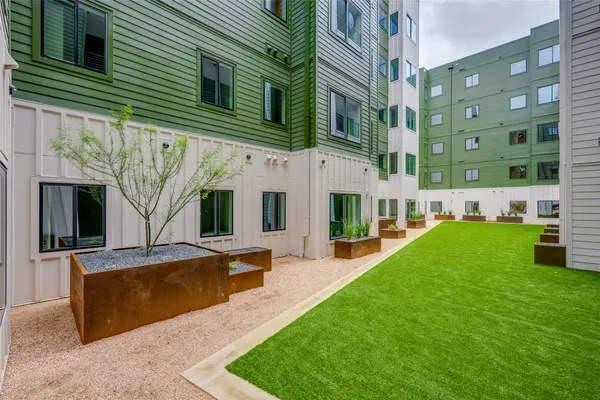 a view of a building with a yard