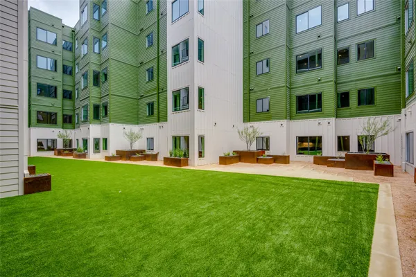 a view of a street with a big yard and a fountain