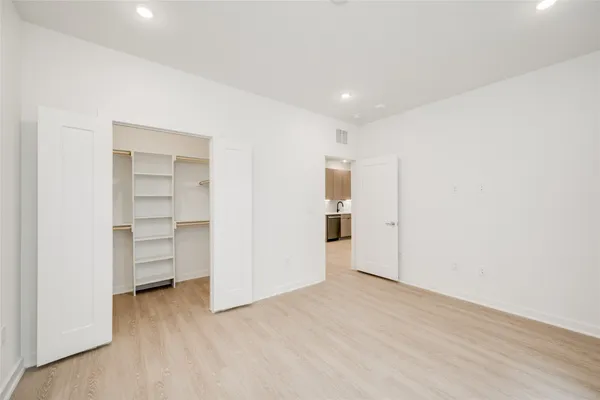 a view of empty room with wooden floor
