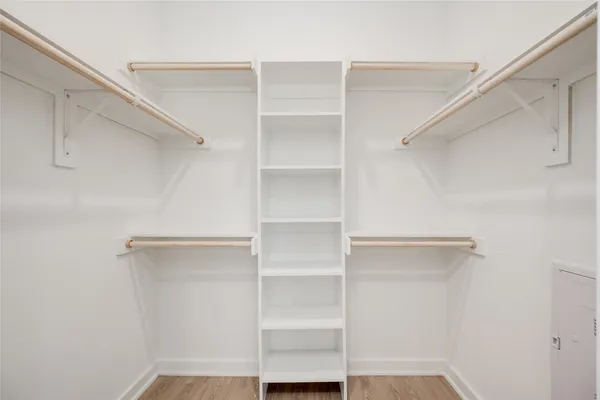 a view of walk in closet with empty racks