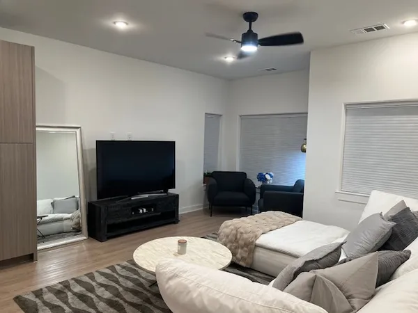 a living room with furniture and a flat screen tv