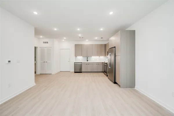 a view of a kitchen with a refrigerator and a sink