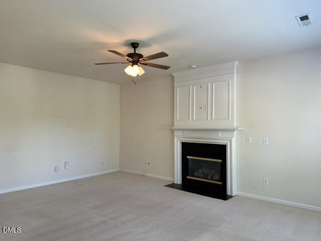 103 Rock River Road Morrisville, NC 27560 - Photo 7 of 18 an empty room with fireplace and fan