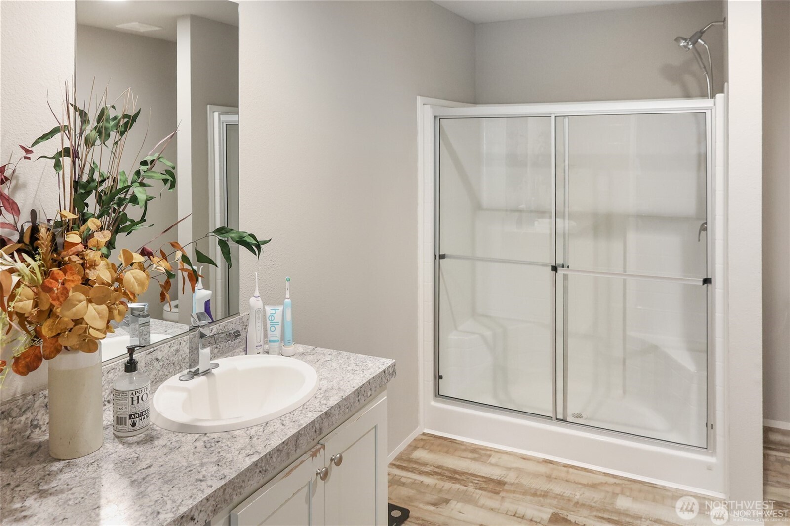 6236 Azure Way Maple Falls, WA 98266 - Photo 10 of 14 a bathroom with a granite countertop sink a mirror and a shower