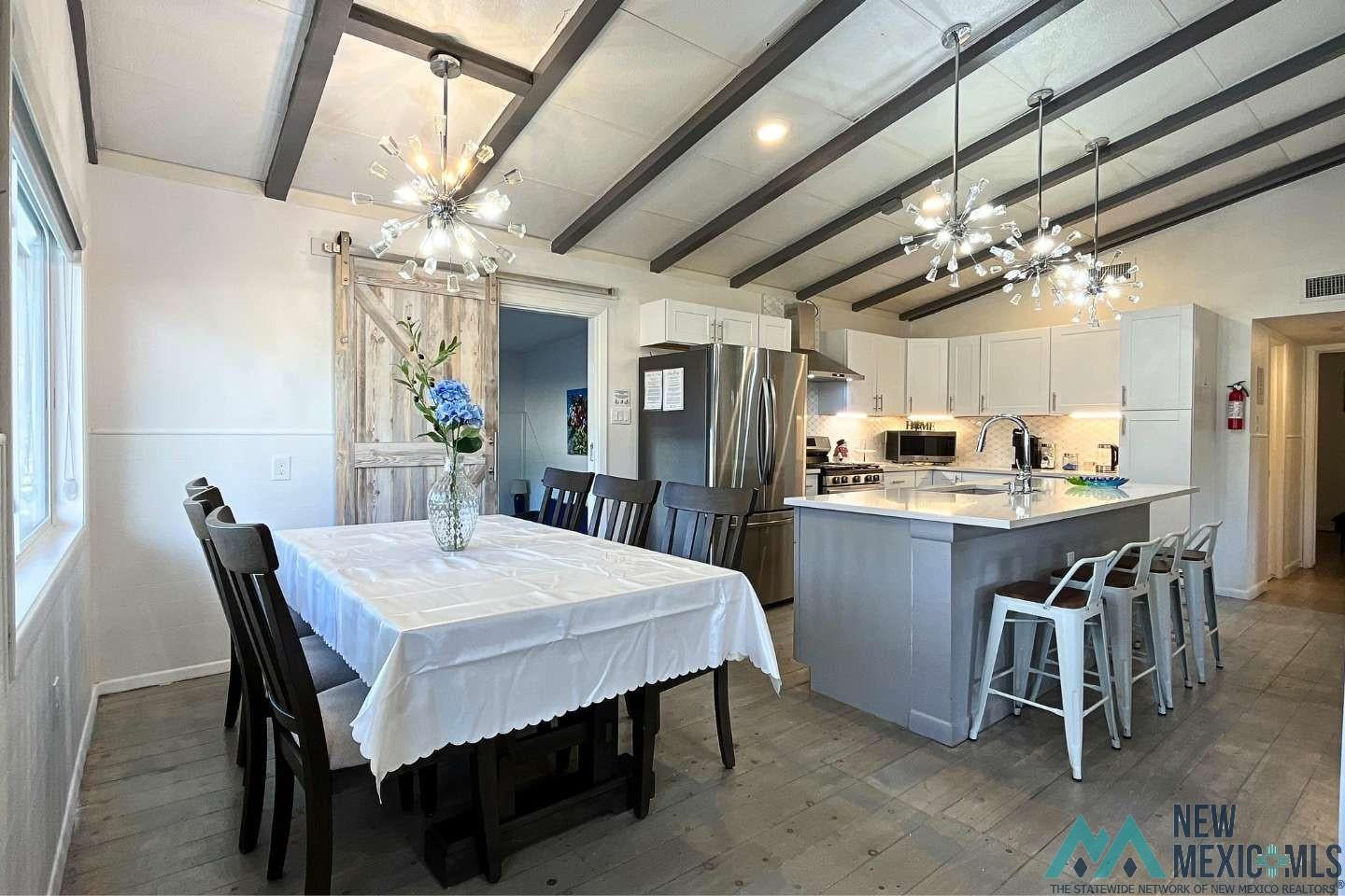 241 Junction Road Ruidoso, NM 88345 - Photo 11 of 44 Dining space with a chandelier and light wood-style floors