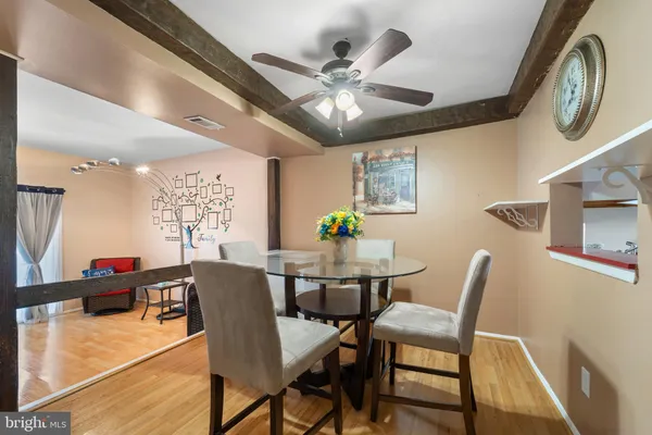 a view of a dining room with furniture and a chandelier