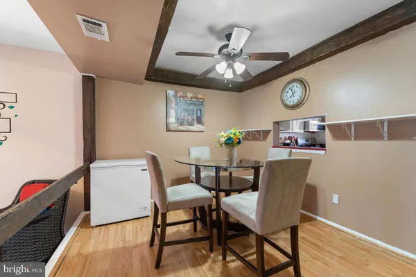 a view of a dining room with furniture and wooden floor