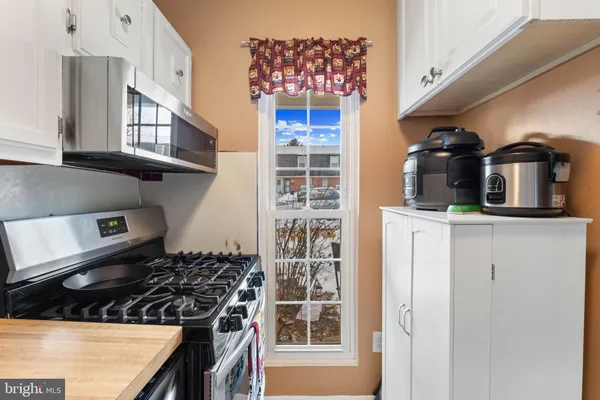 a kitchen with a stove and a wooden cabinets