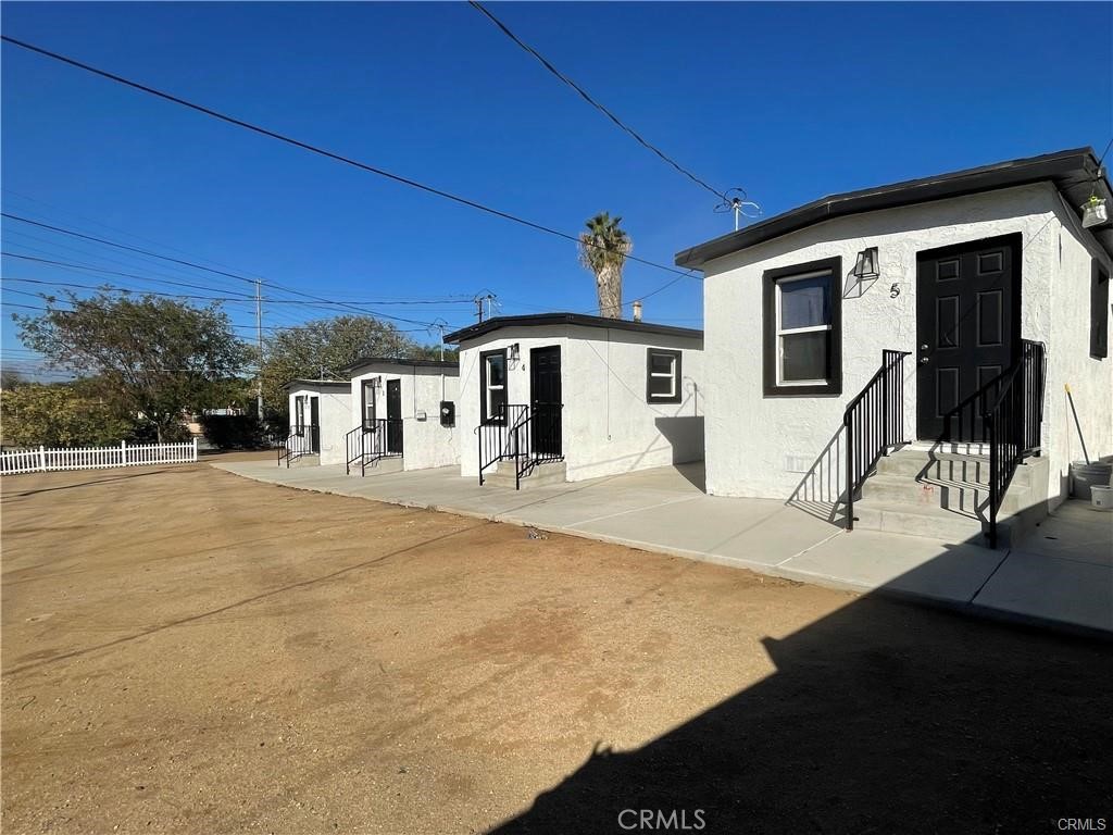 10098 Campbell Avenue, Unit 4 Riverside, CA 92503 - Photo 1 of 17 a front view of a house with a yard
