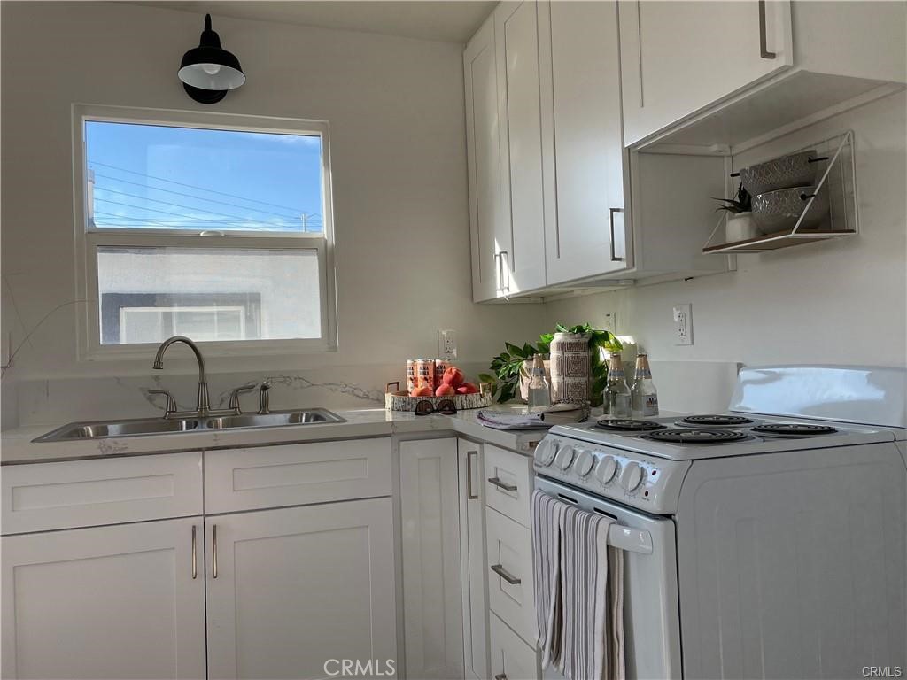 10098 Campbell Avenue, Unit 4 Riverside, CA 92503 - Photo 13 of 17 a kitchen with stainless steel appliances a sink stove and cabinets