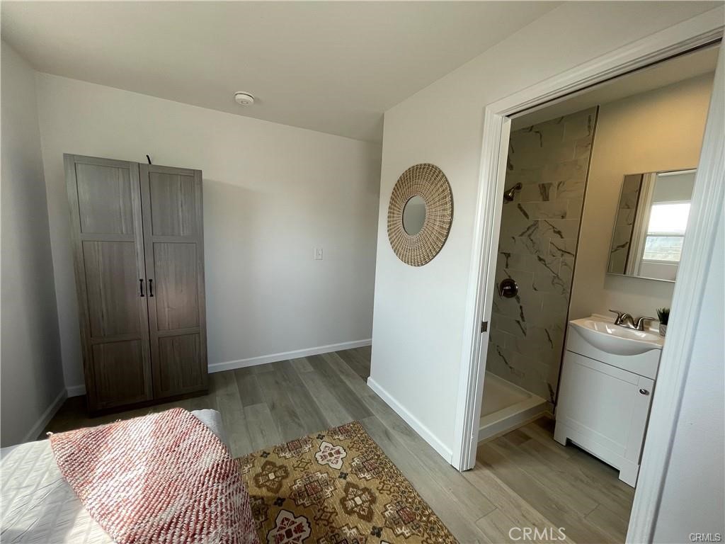 10098 Campbell Avenue, Unit 4 Riverside, CA 92503 - Photo 7 of 17 a bedroom with a bed and a mirror