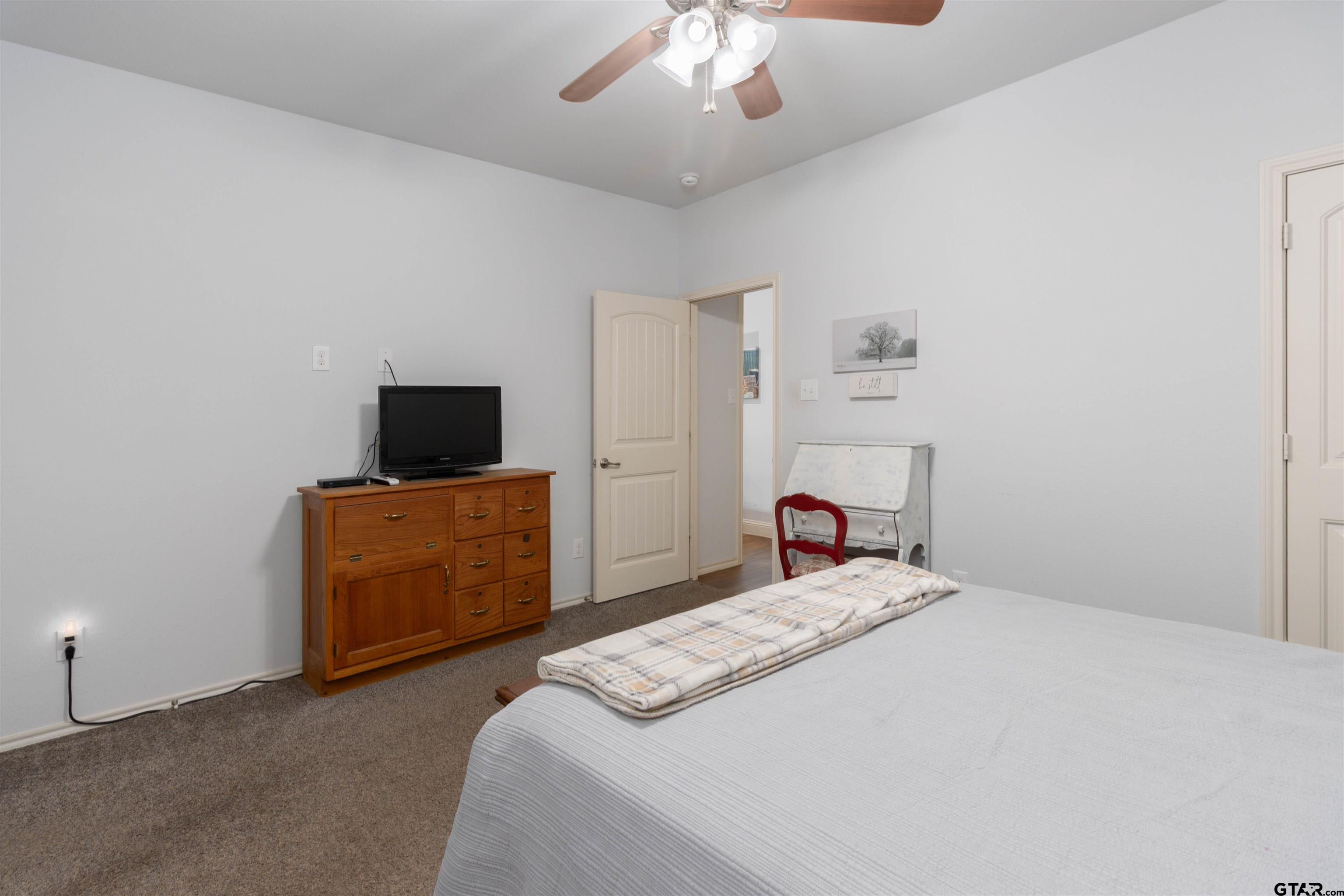 18424 Walnut Circle Flint, TX 75762 - Photo 11 of 26 a bedroom with a bed and a flat screen tv