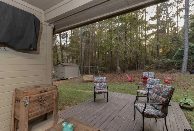 a backyard of a house with table and chairs