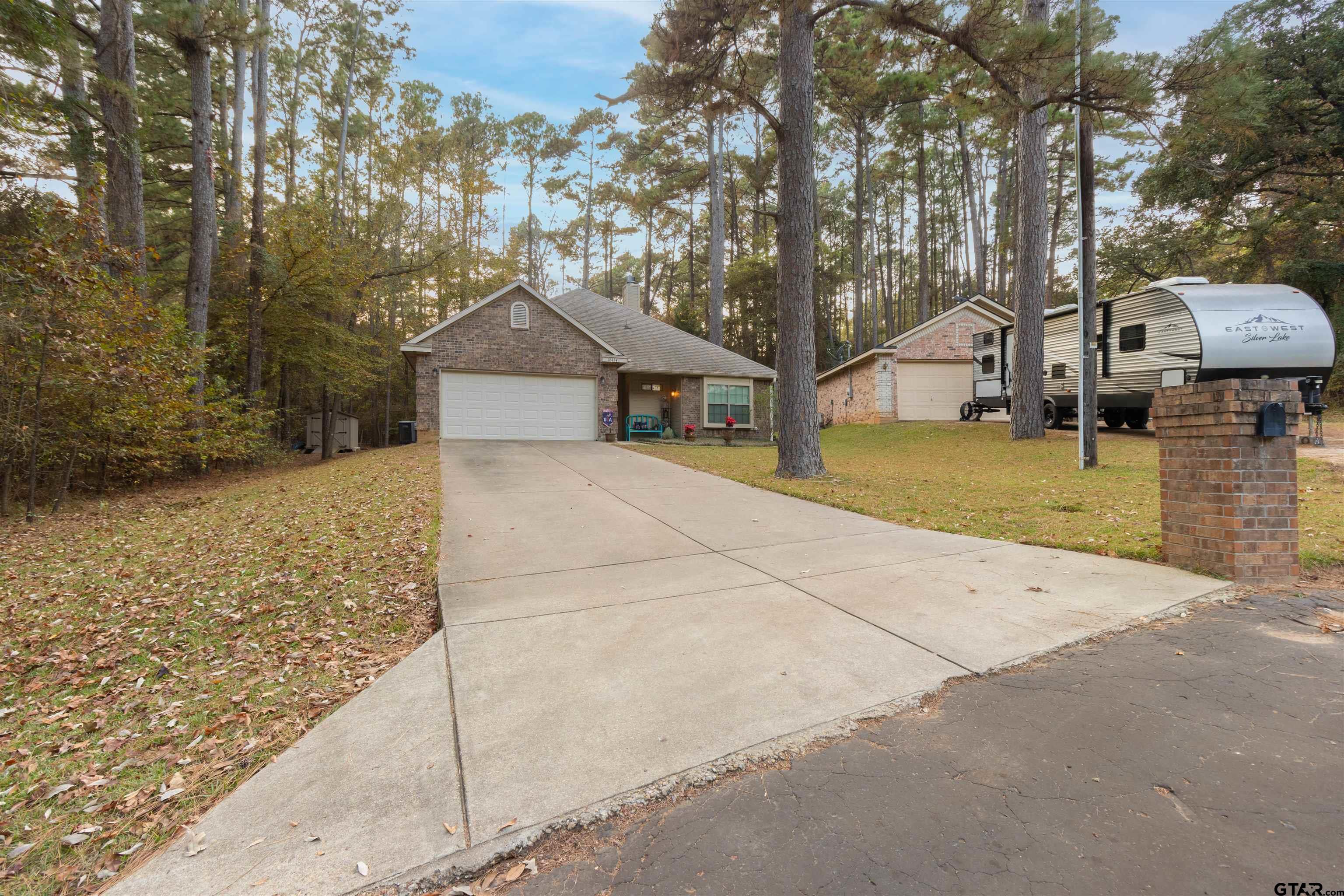 18424 Walnut Circle Flint, TX 75762 - Photo 2 of 26 a house with trees in the background