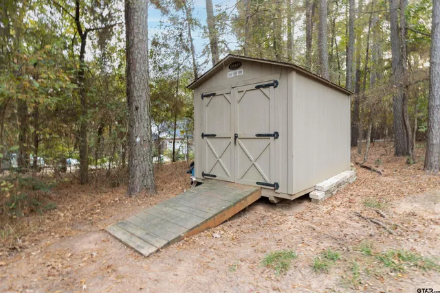 a view of a wooden house with a yard