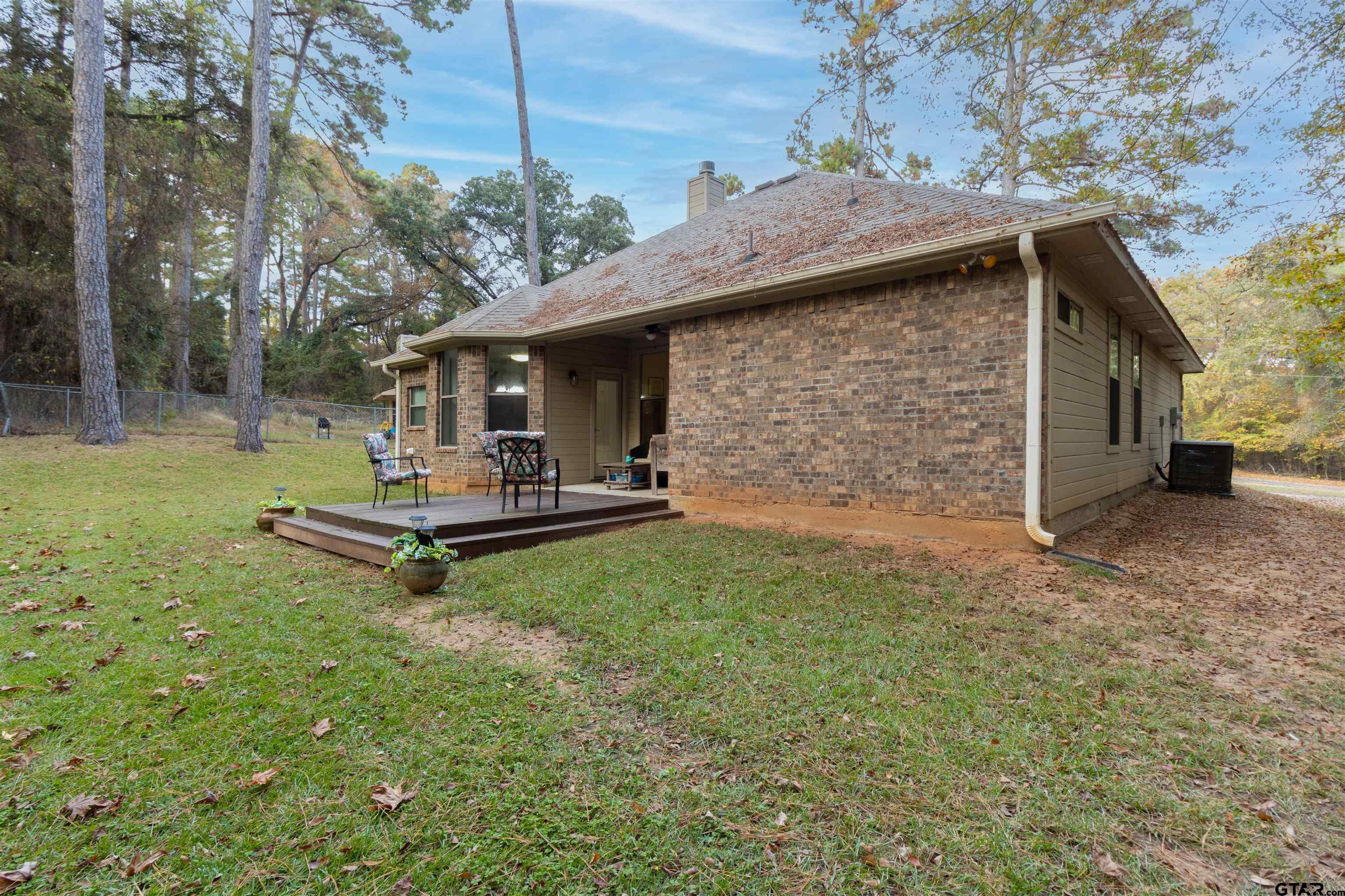 18424 Walnut Circle Flint, TX 75762 - Photo 23 of 26 a backyard of a house with table and chairs