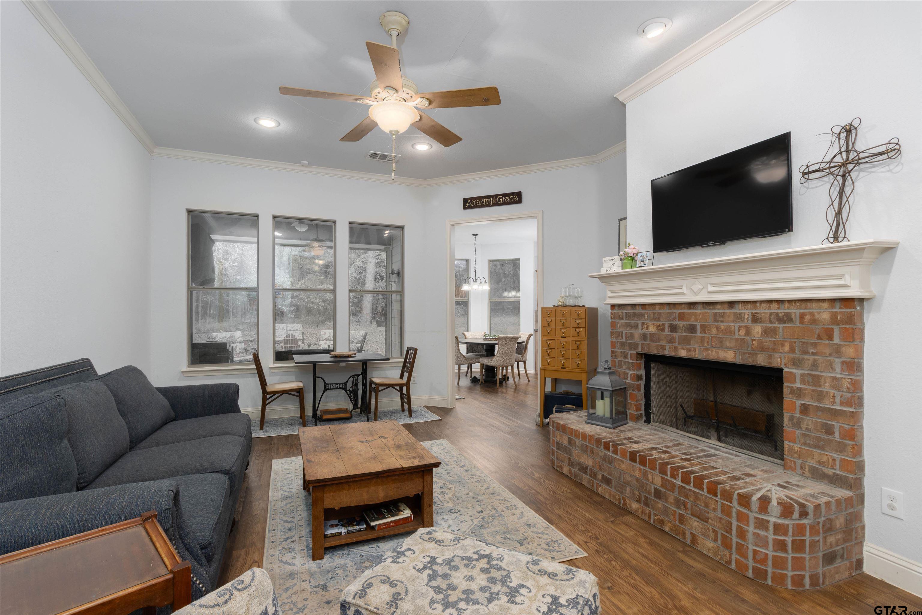 18424 Walnut Circle Flint, TX 75762 - Photo 4 of 26 a living room with furniture a flat screen tv and a fireplace