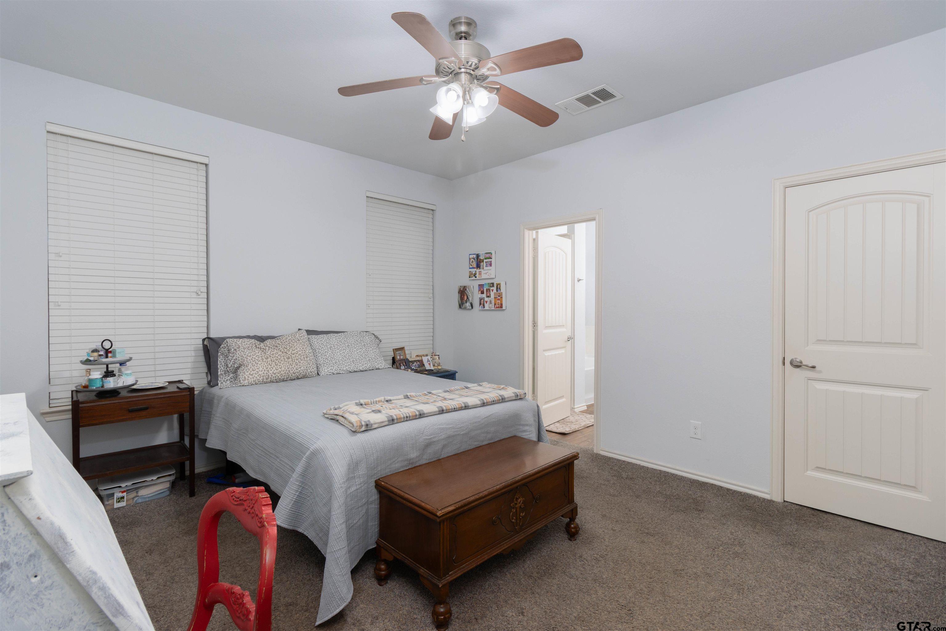 18424 Walnut Circle Flint, TX 75762 - Photo 10 of 26 a bedroom with a bed and a chandelier