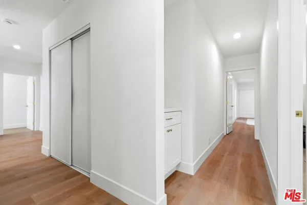 a view of a hallway with wooden floor
