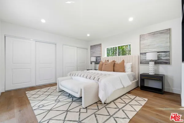 a spacious bedroom with a bed and a table